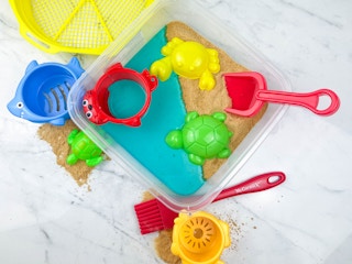 a beach themed diy sensory bin sitting on a counter