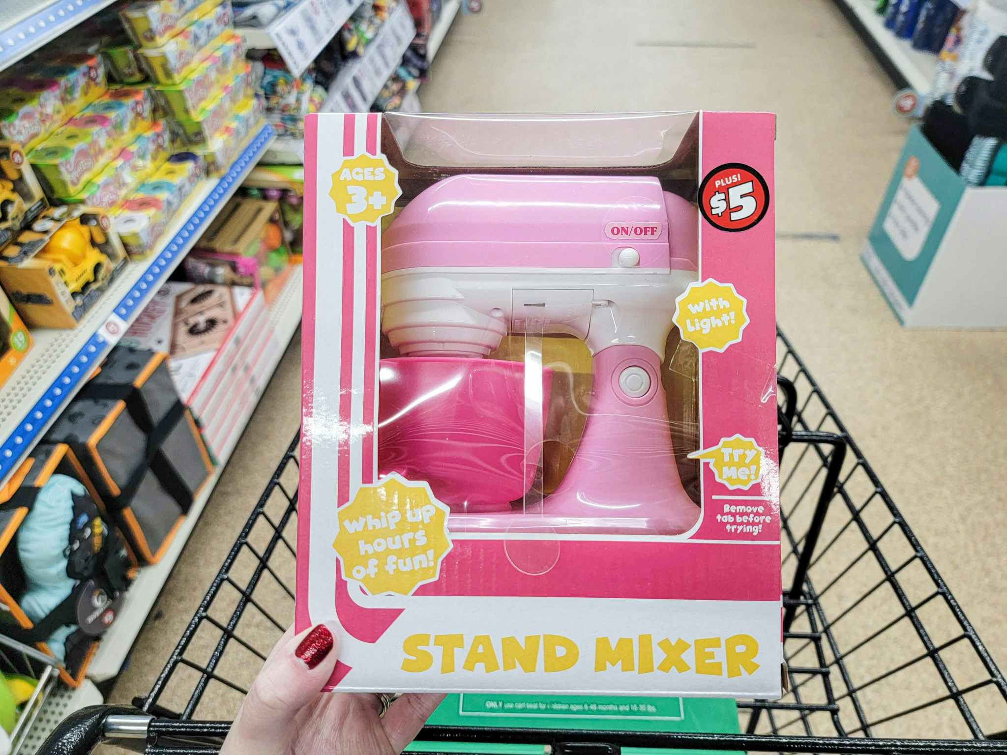hand holding a kids stand mixer toy