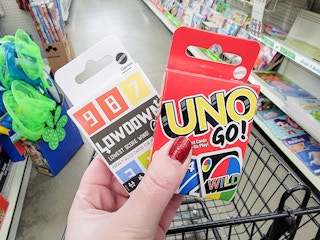 hand holding 2 mattel mini card games