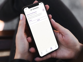 a person looking at the taco bell app on their iphone