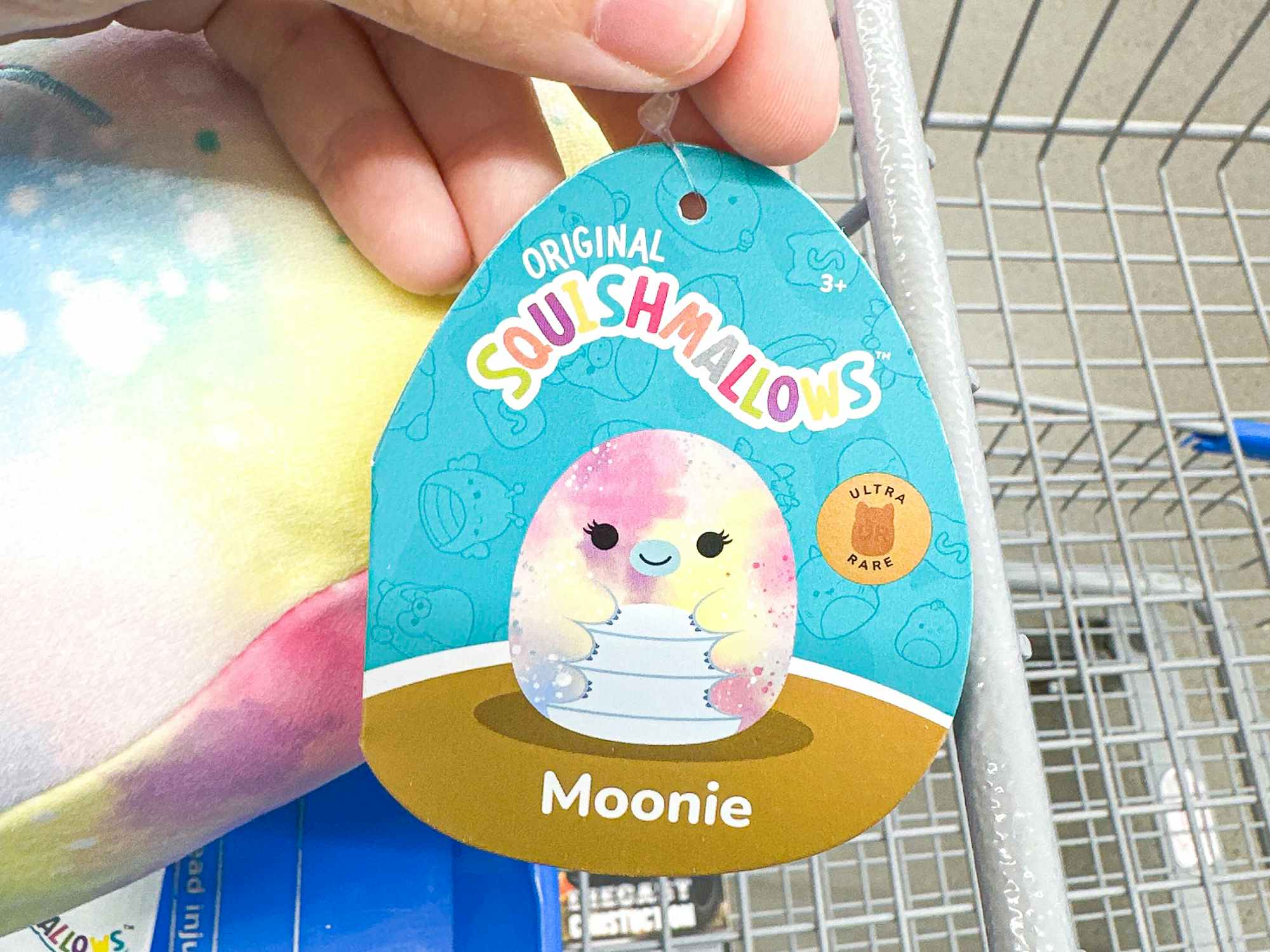 Someone holding a Ultra Rare tag for the Moonie waterbear Squishmallow at Five Below
