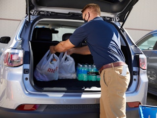person loading groceries into a car