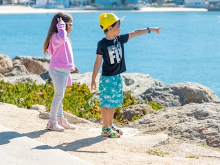 children pointing at lake