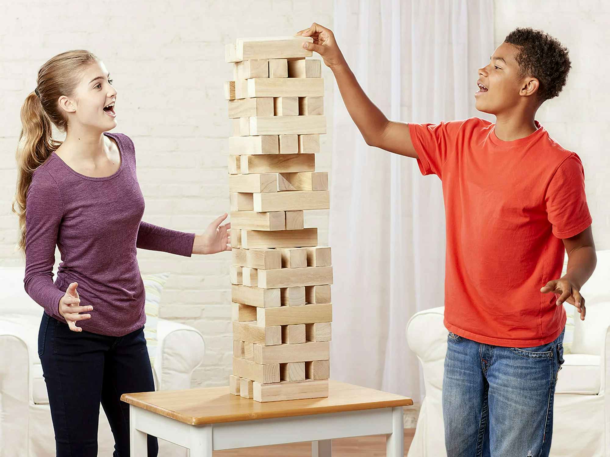 teenagers playing giant jenga jumbling tower