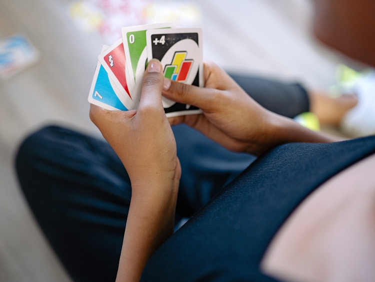 person playing uno card game