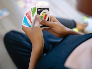 person playing uno card game