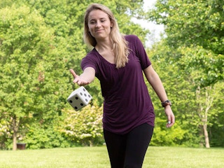 person throwing lawn dice outside