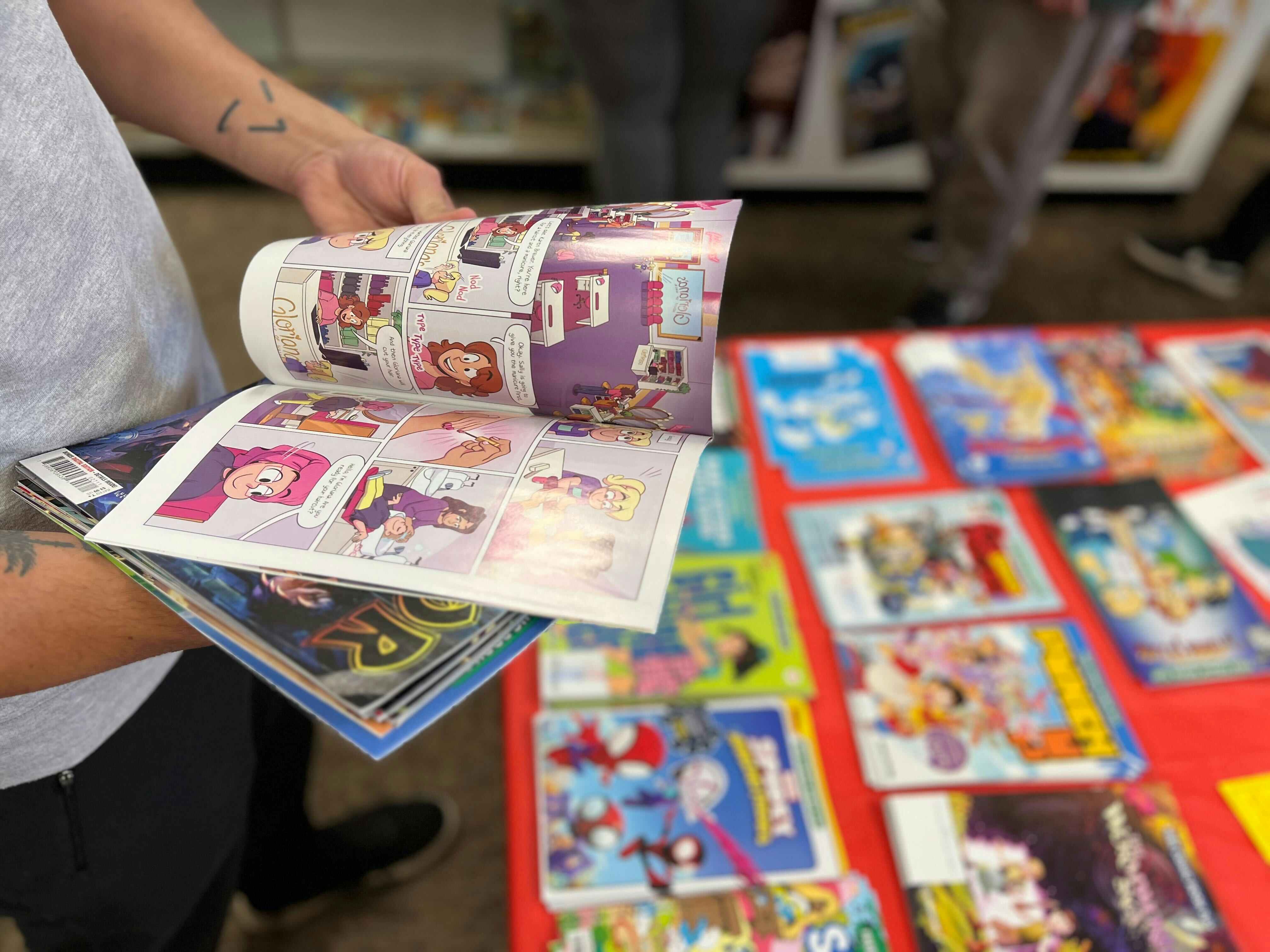 A man flips through one of the issues offered on free comic book day