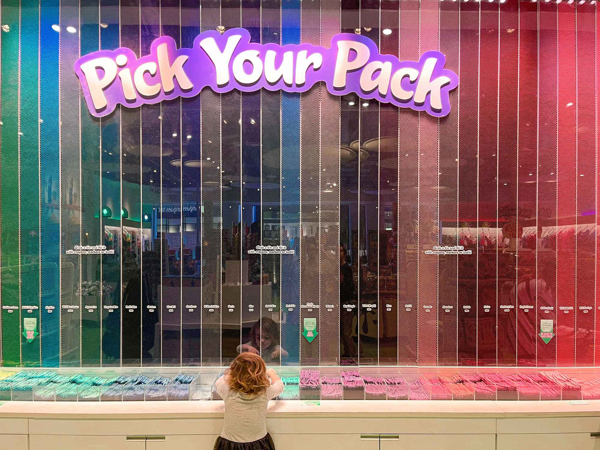 A child picking out crayons at the Crayola Experience location