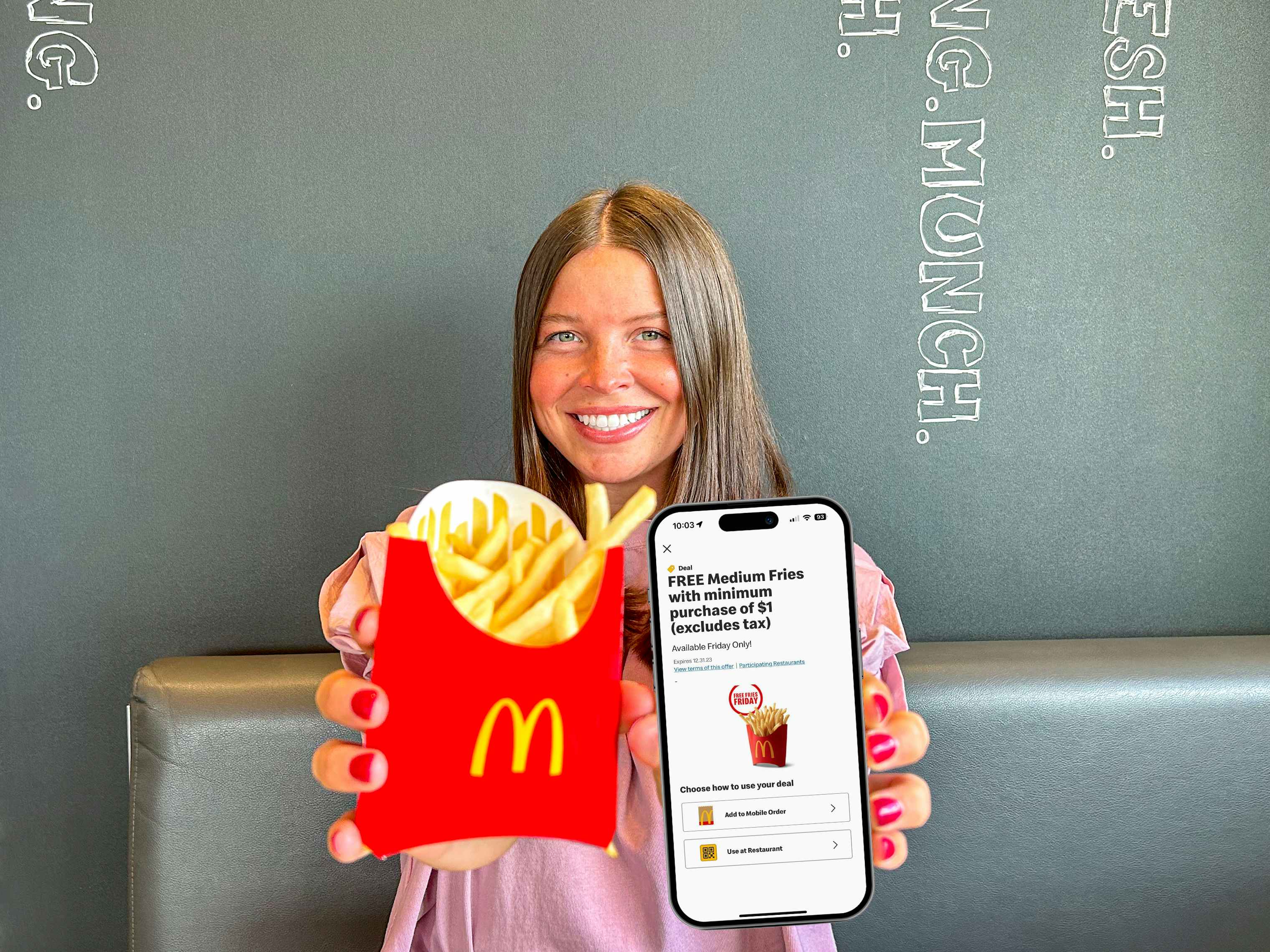 a person holding up fries and a phone with the mcdonalds app on it