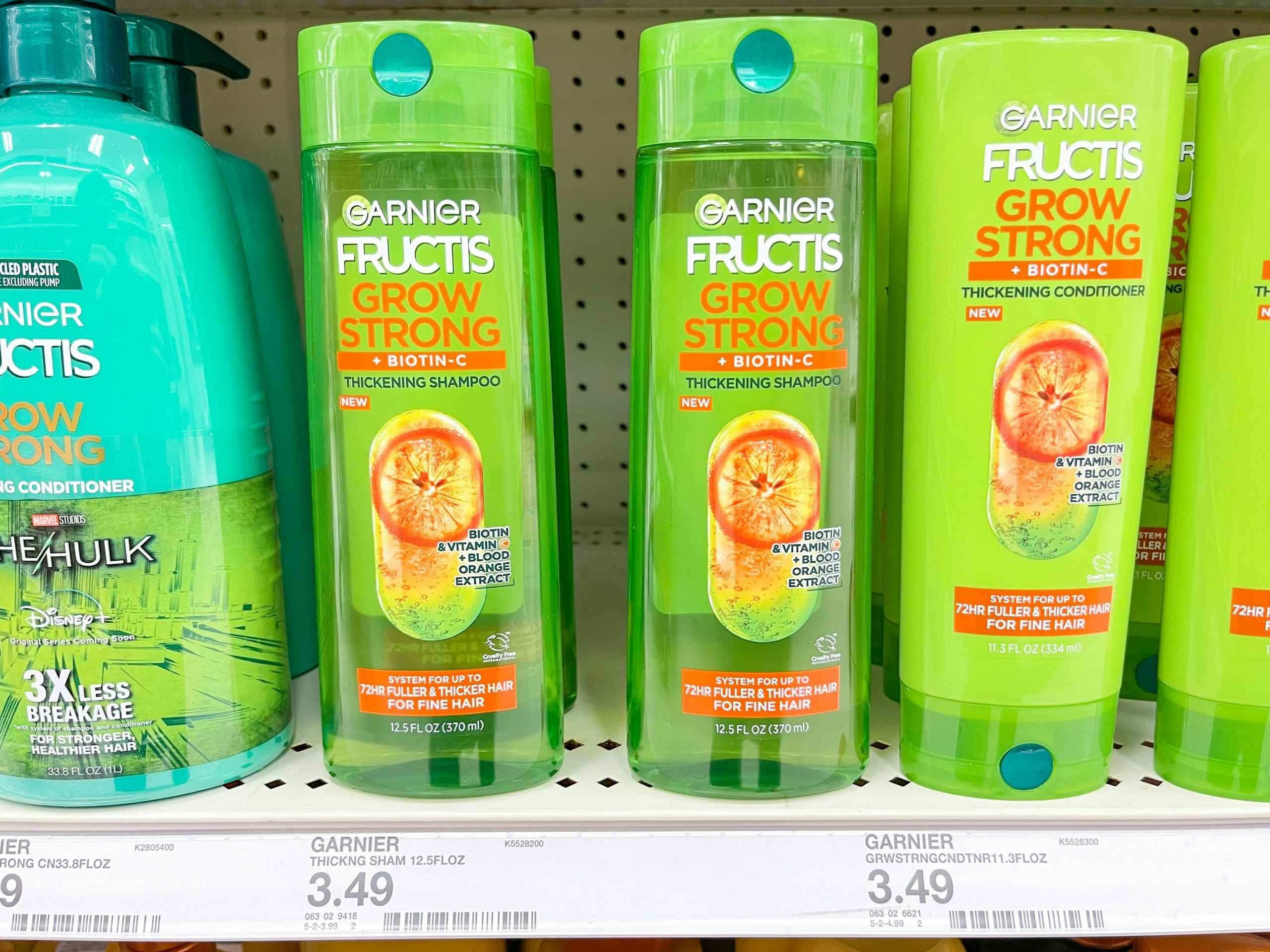 A variety of Garnier Fructis shampoos and conditions sitting on a store shelf.