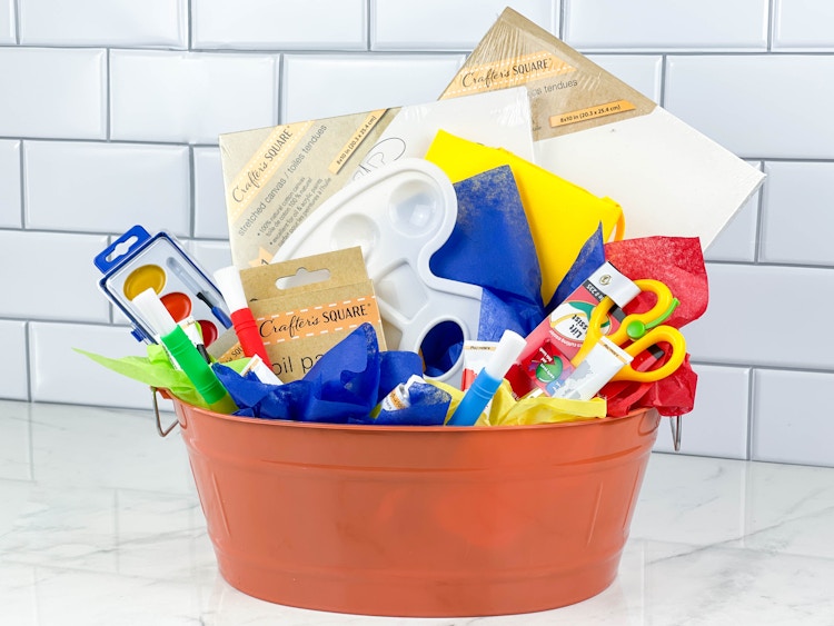 a painted arts and crafts gift basket on counter 