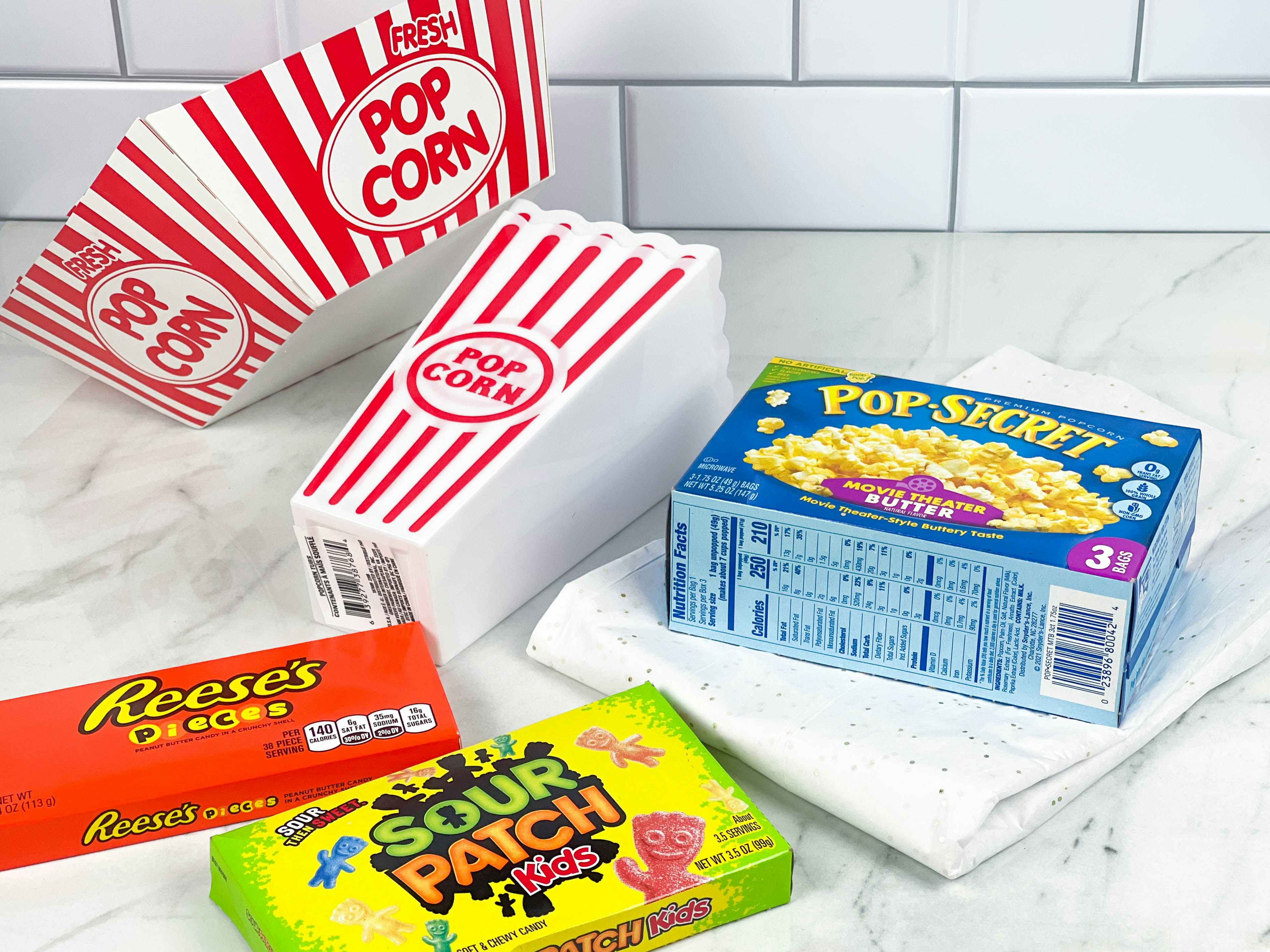 items to make a movie night gift basket on counter