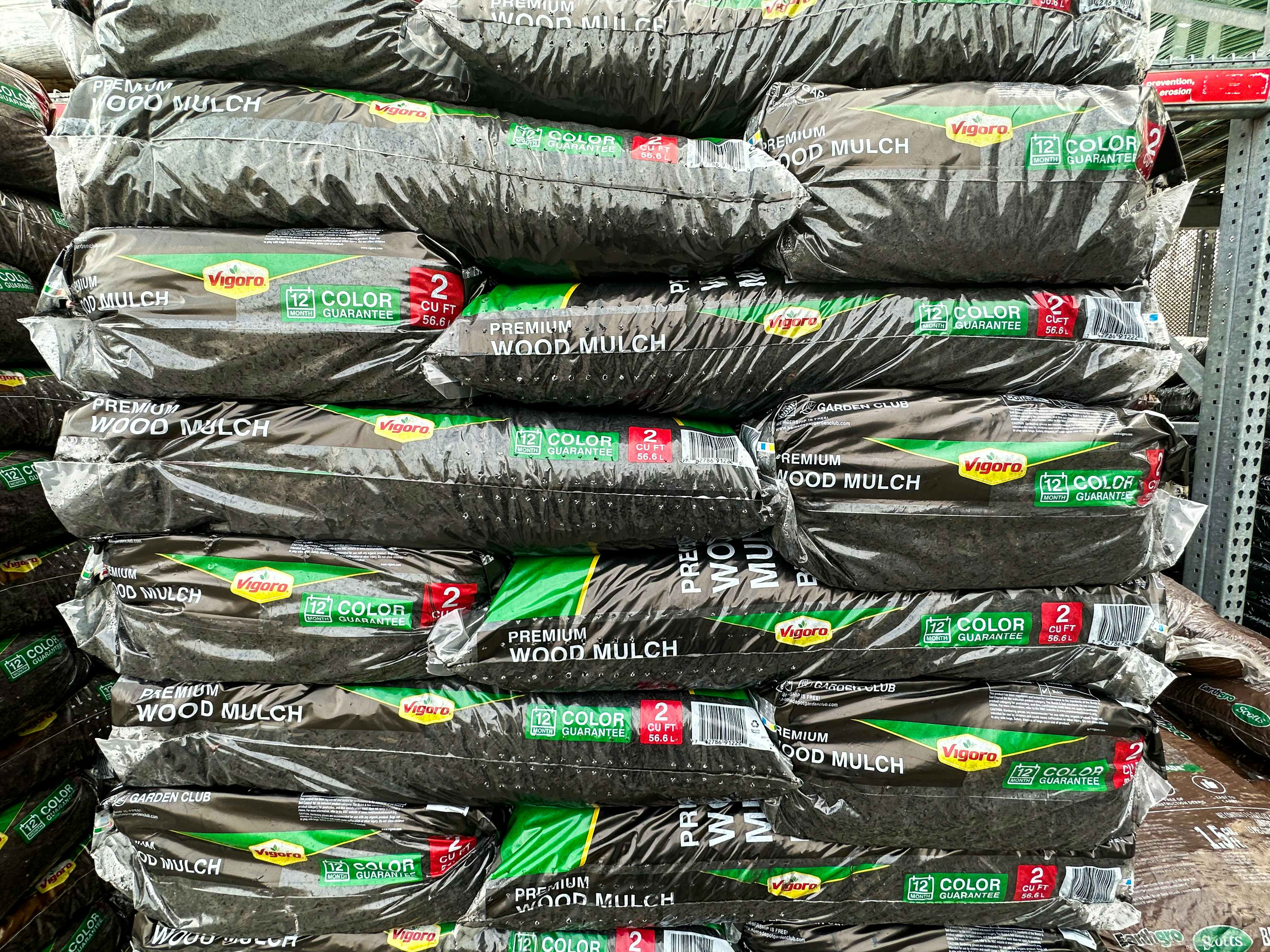 Bags of Vigoro Premium Wood Mulch stacked on top of one another at the Home Depot garden center