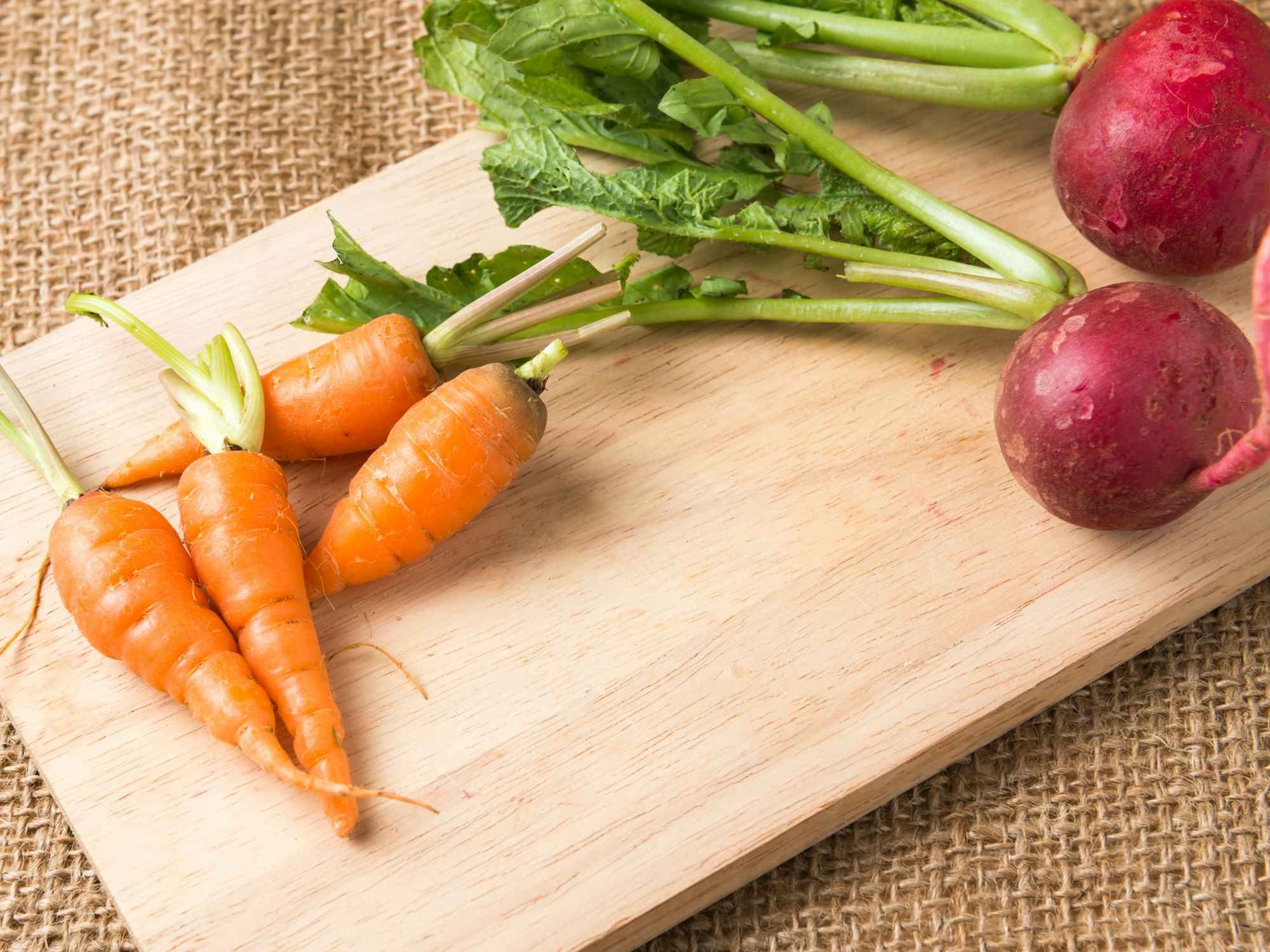 carrots and radish on a cutting board