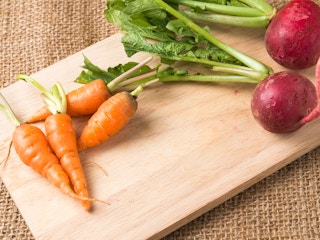 carrots and radish on a cutting board
