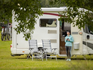 a person standing outside of their RV
