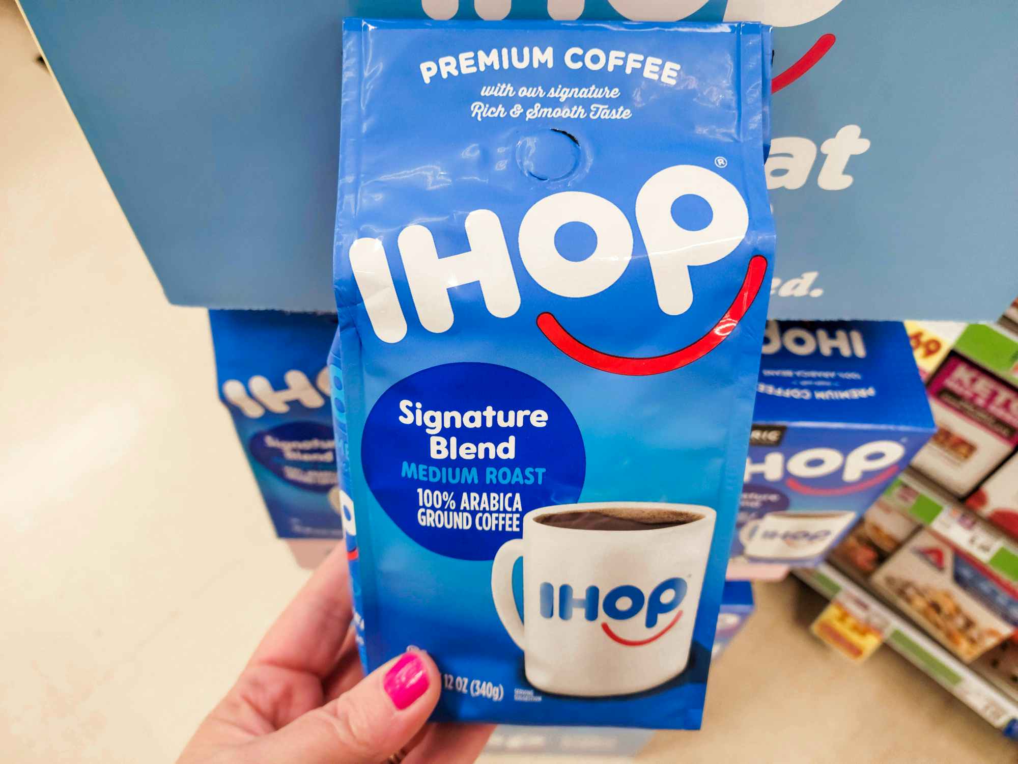 Someone holding up a bag of IHOP coffee