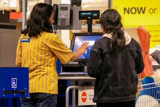 An employee assisting a customer to check out at IKEA