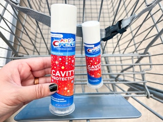 hand holding toothpaste newa shopping cart