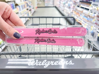 hand holding two revlon nail files