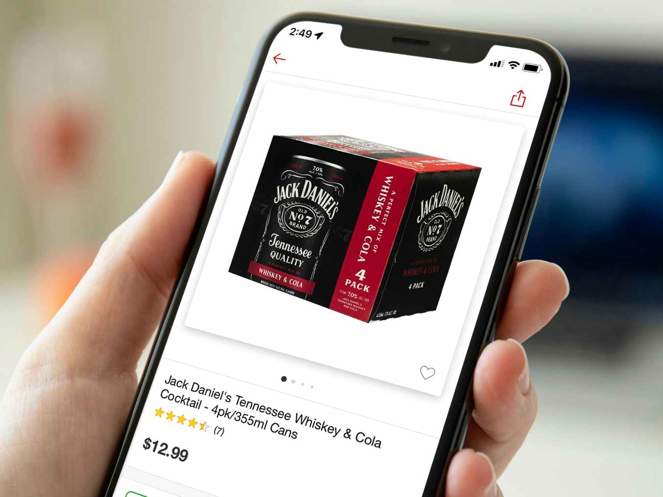 person holding phone with jack daniels coca-cola cans product screenshot