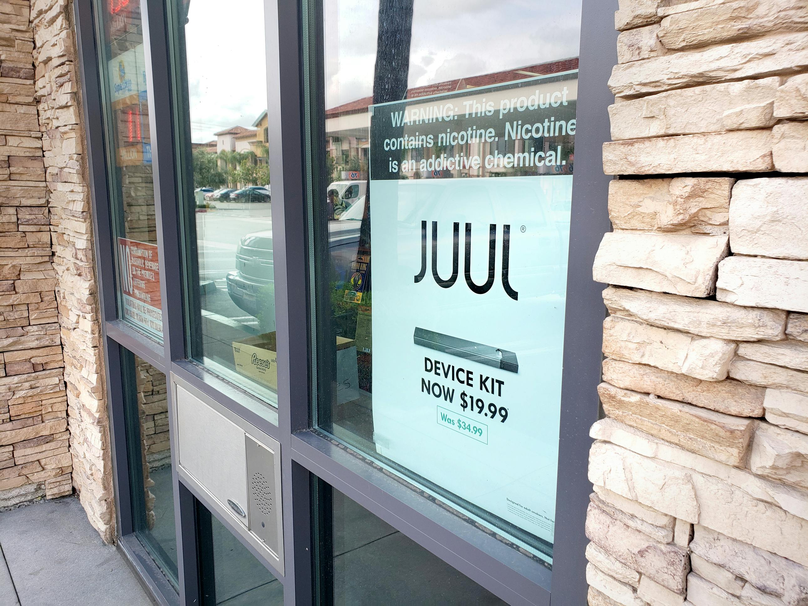 A sign outside a convenience store advertising Juul e-cigarettes.