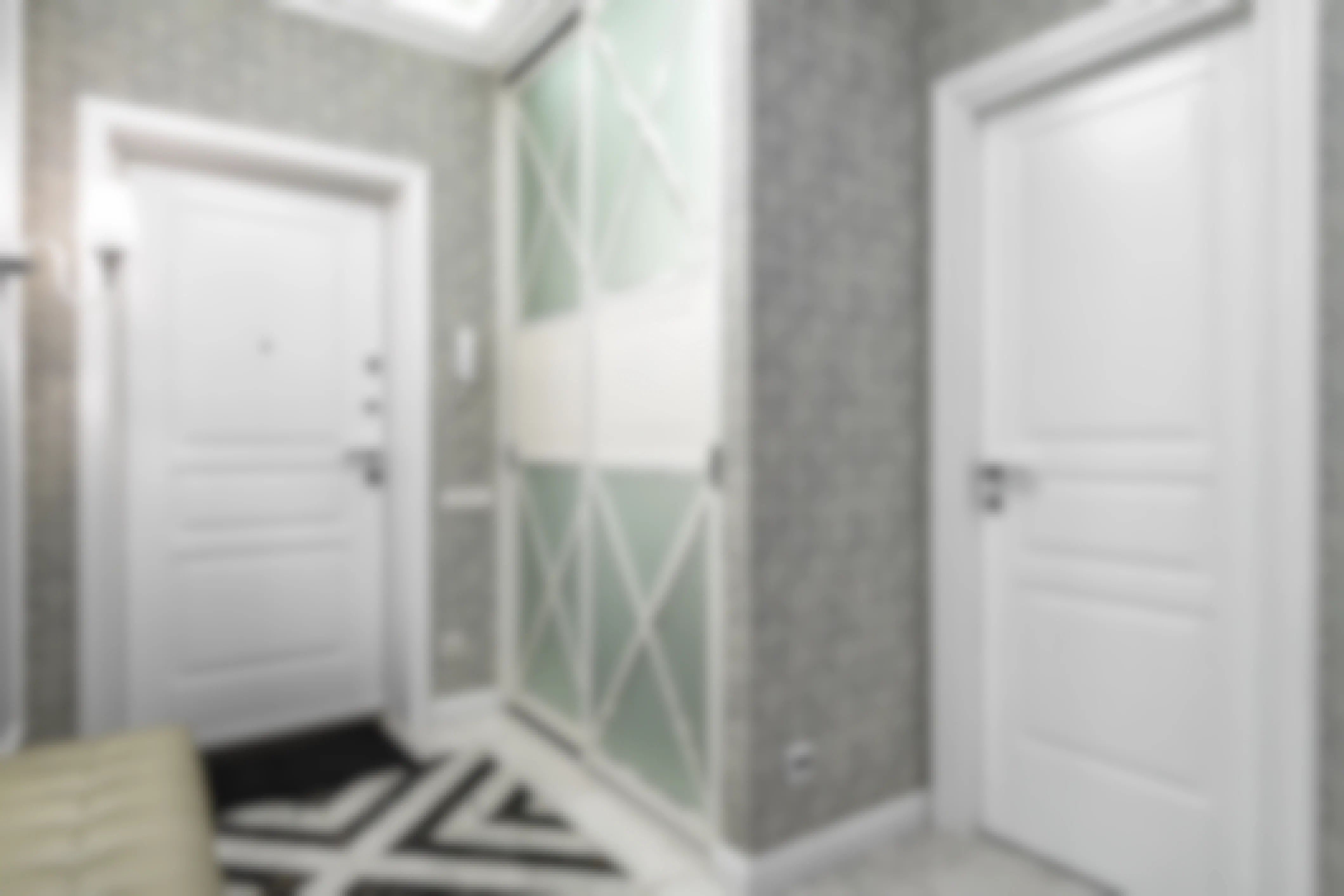 A bathroom lined with grey geometric wallpaper