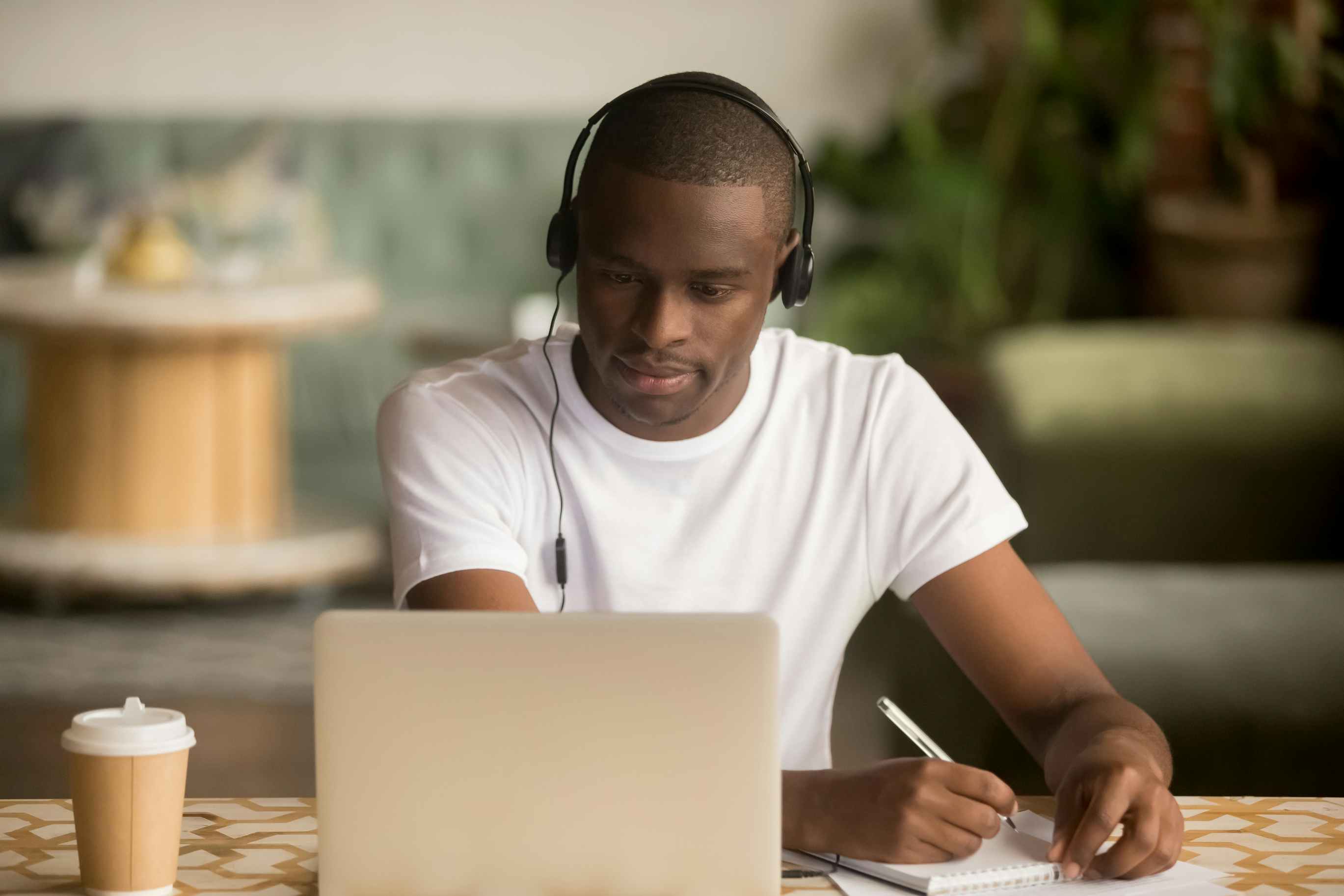 Man looking at laptop with headphones
