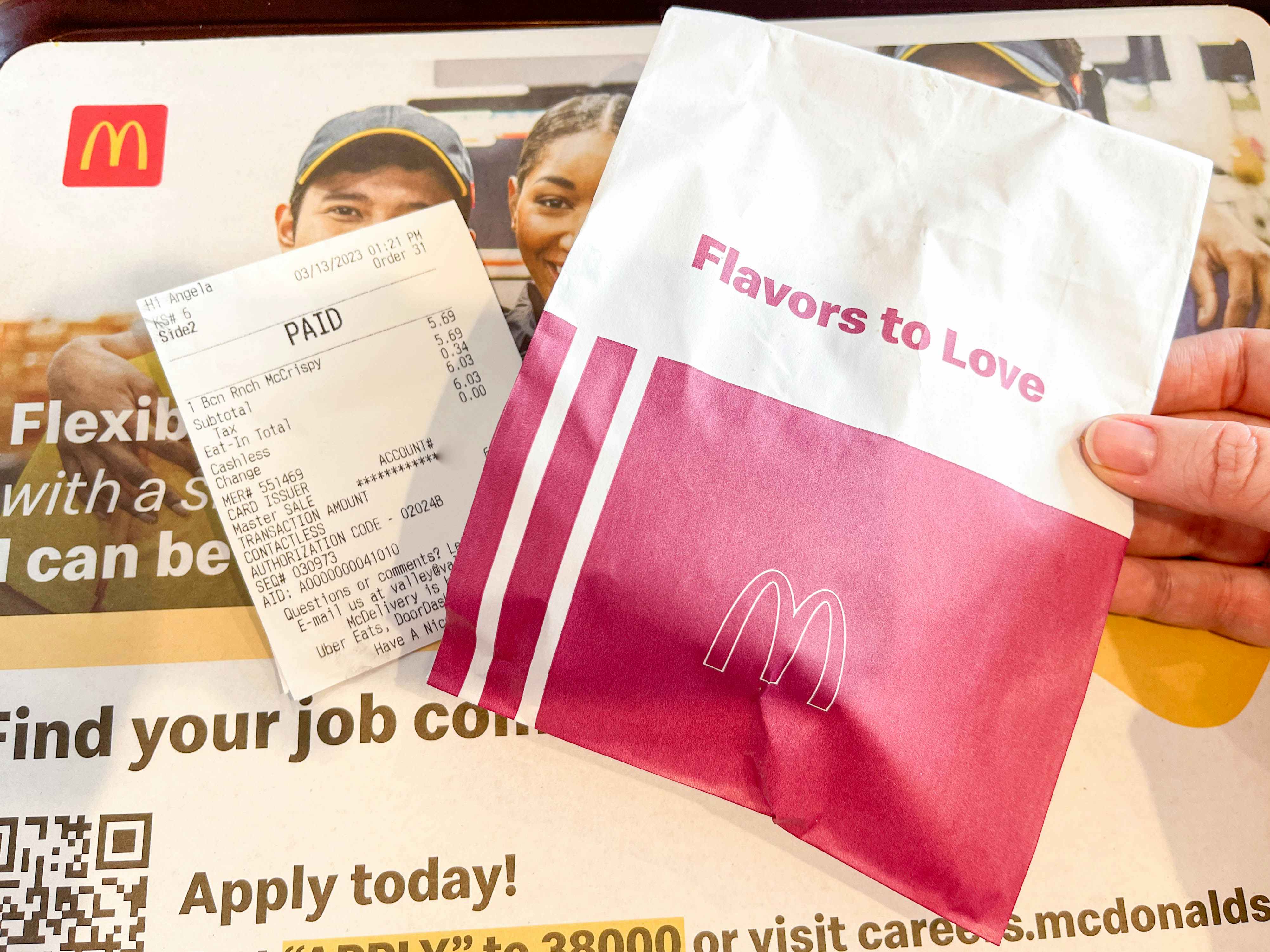 mcdonalds mccrpisy sandwich in bag on a tray next to receipt