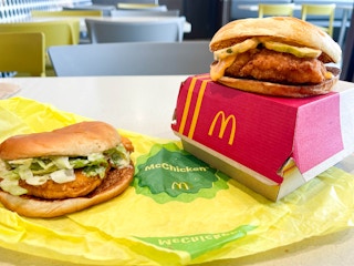 two mcdonald chicken sandwiches next to each other with on on a box