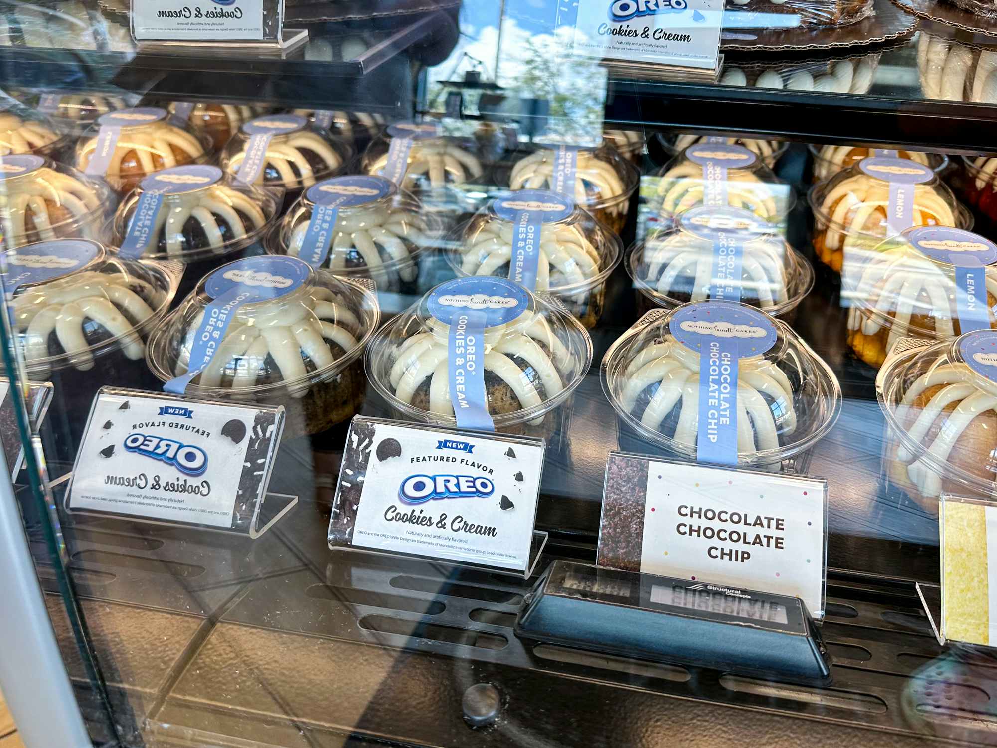 Bundt cakes in a display case inside a Nothing Bundt Cake shop