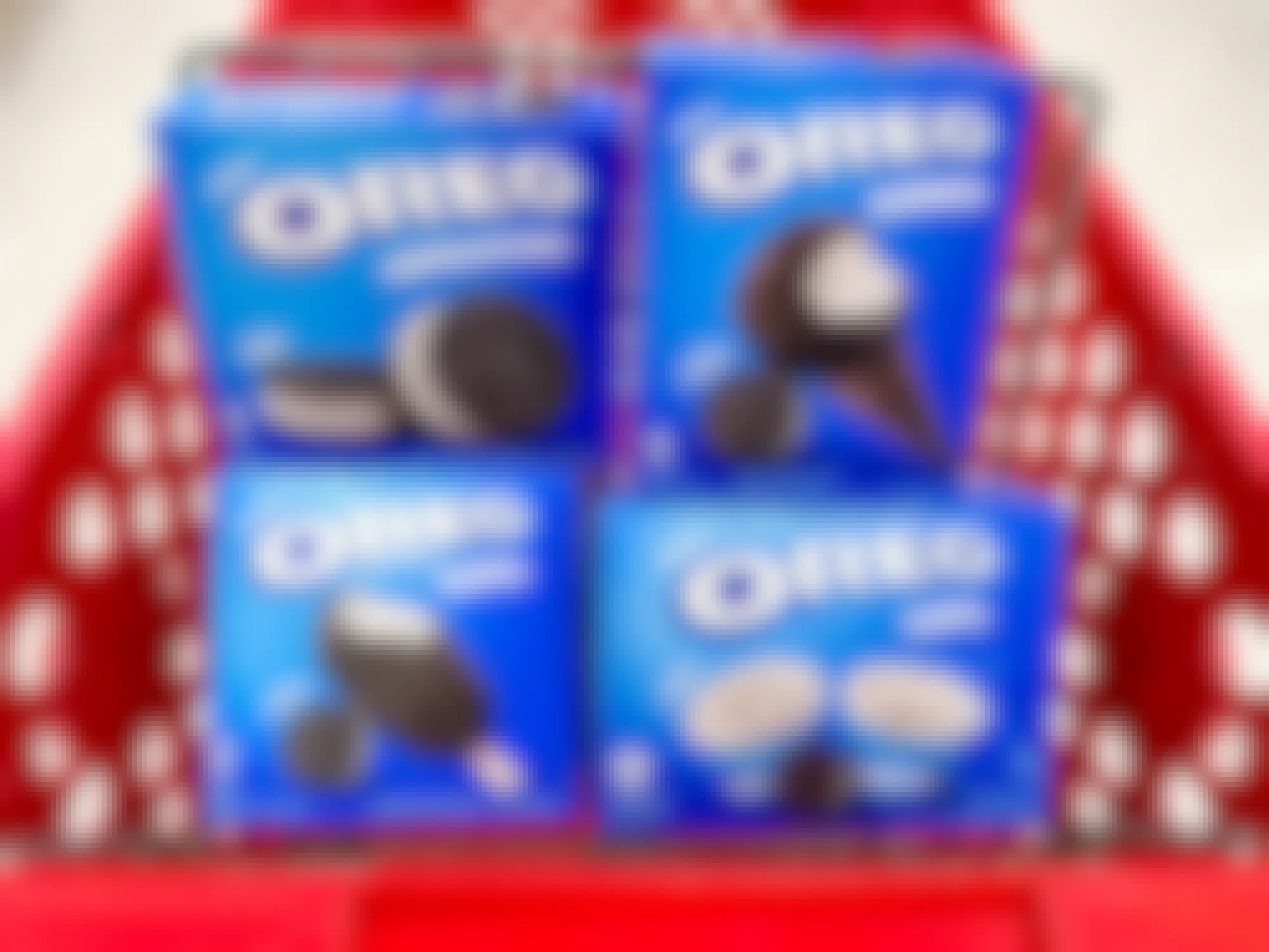 Four boxes of different kinds of Oreo frozen treats stacked in a Target cart