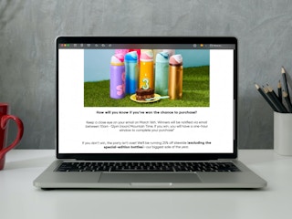 A laptop on a desk displaying an email about the Owala Special Edition bottle raffle