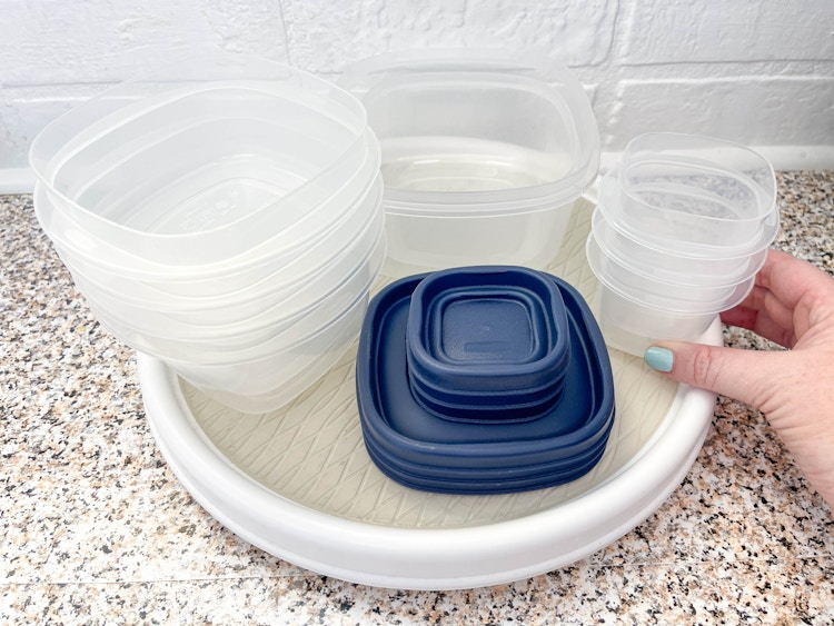 Tupperware on a lazy susan in a cabinet 