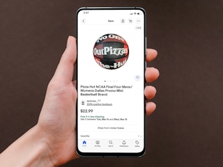 person holding phone with original pizza hut mini basketball for sale on ebay