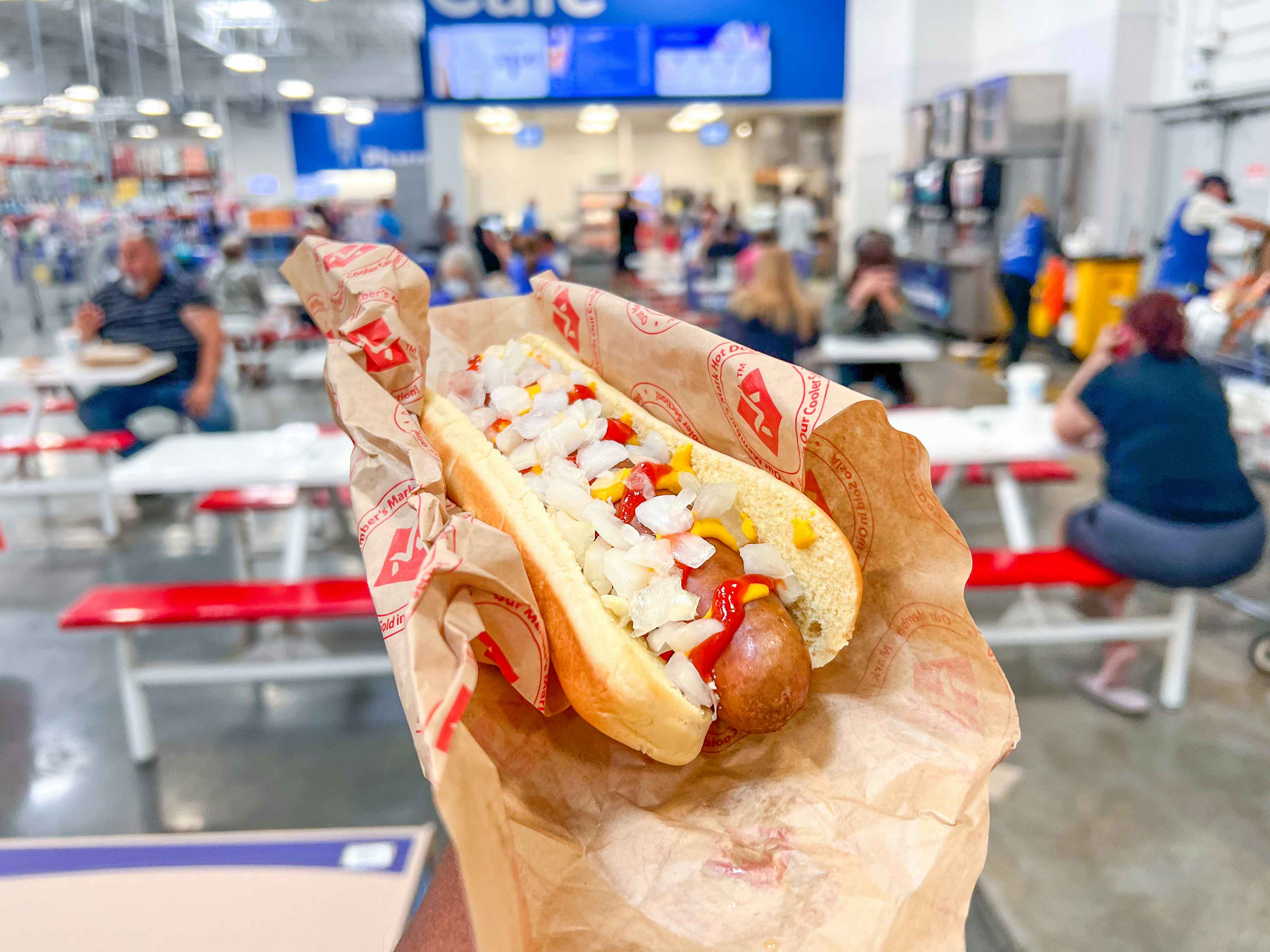 hand holding a Sam's Club Hot Dog inside the store