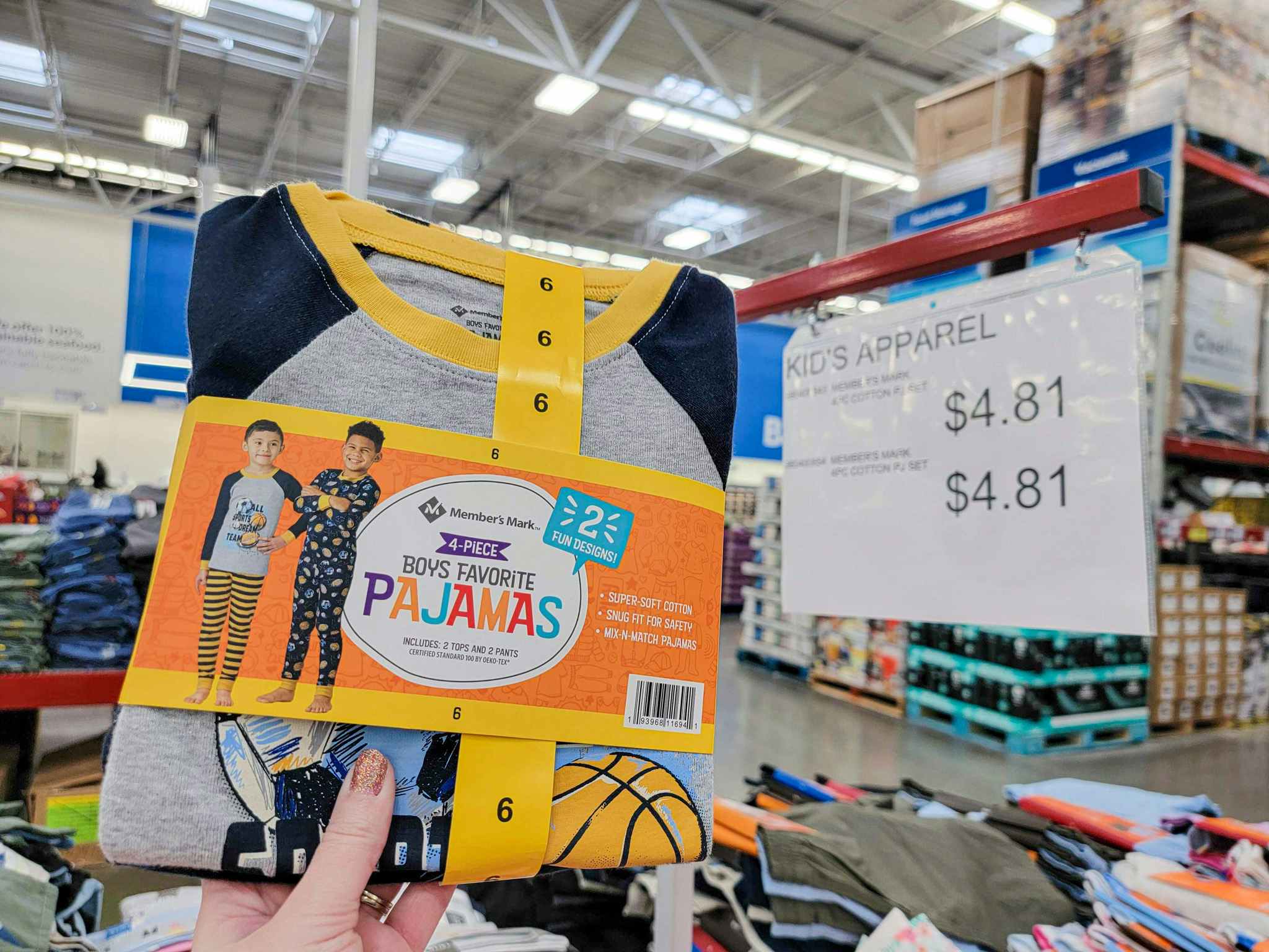 hand holding kids pajamas by a clearance sign for 4.81