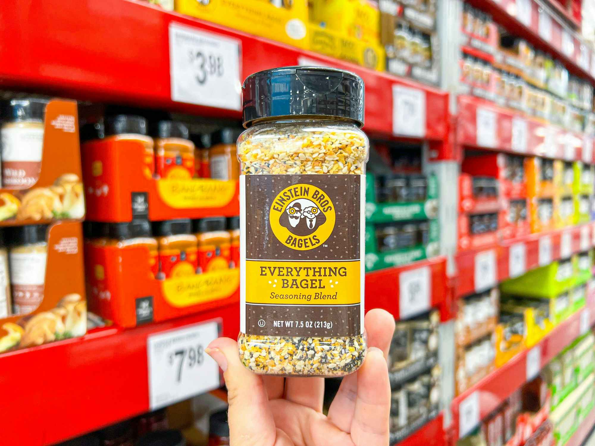 someone holding up some seasoning in Sam's Club