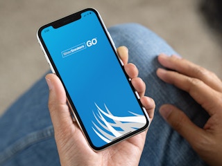 a person looking at the silver sneakers app on their iphone