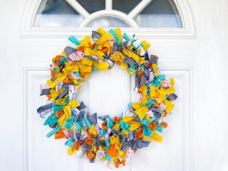A rag wreath hanging on a door 