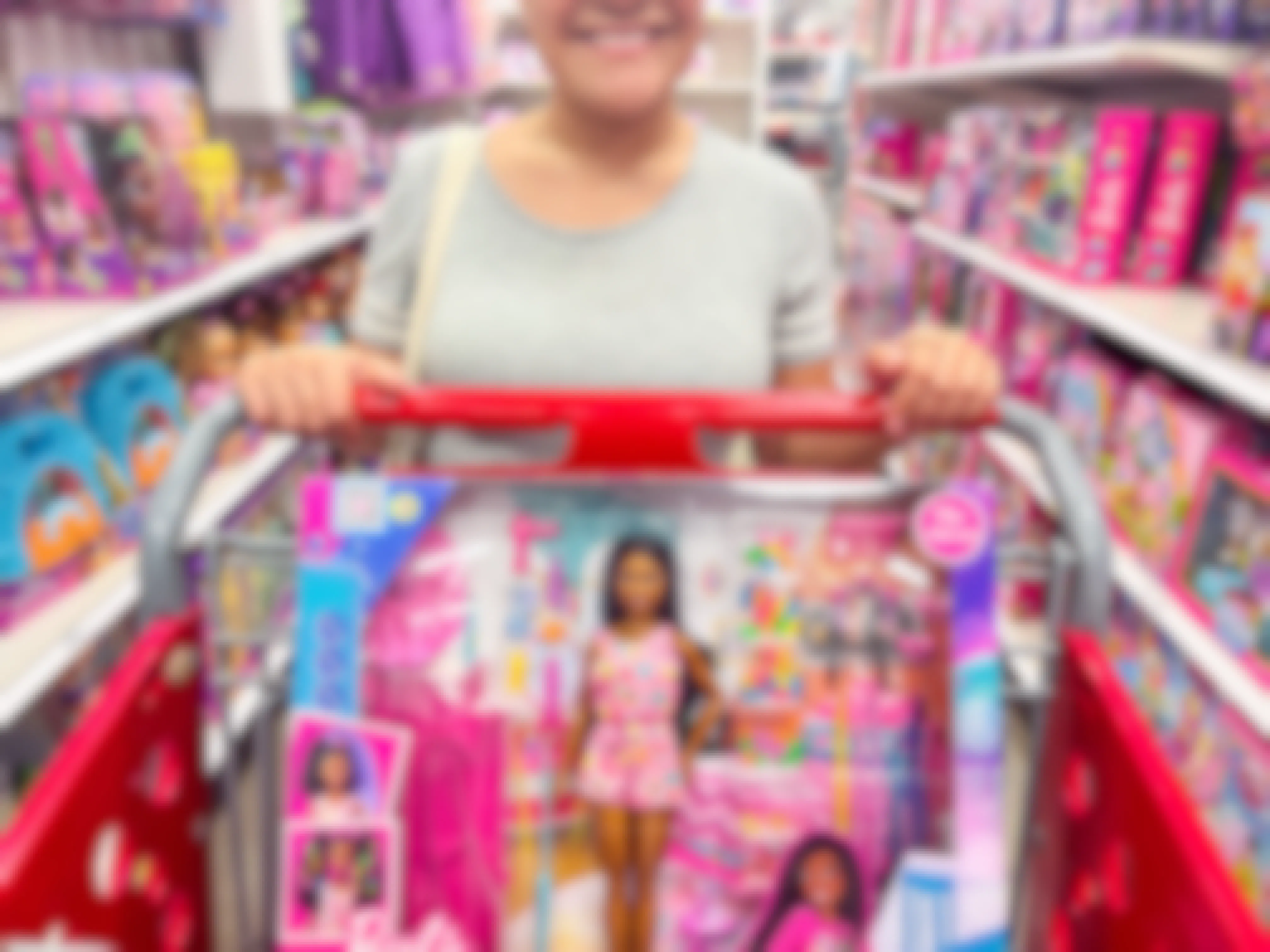 Person pushing a cart with a barbie toy inside