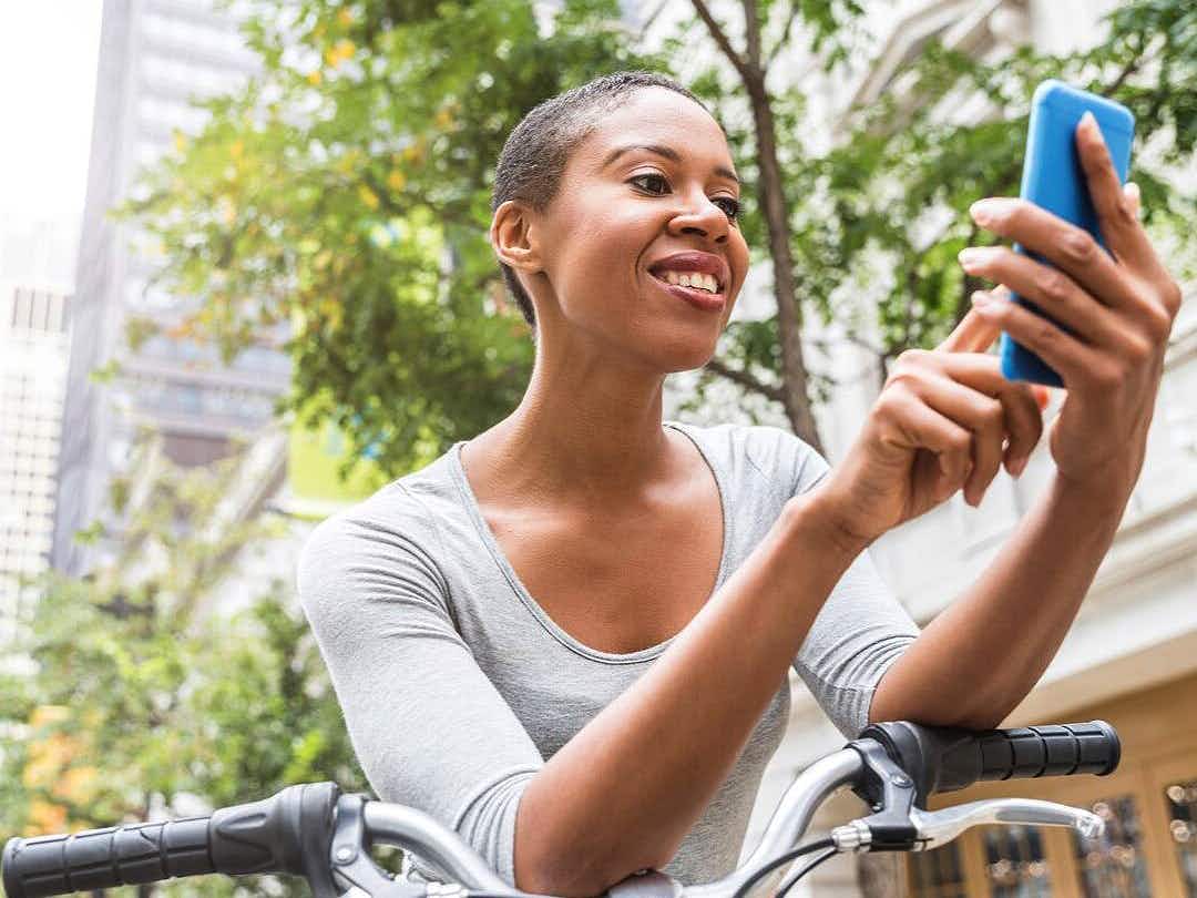 person on bike looking at phone