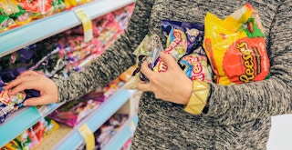 person picking up easter candy off of the walgreens shelf