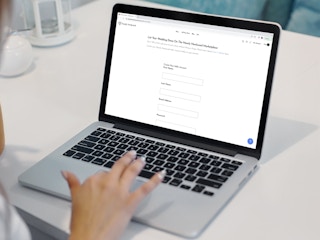 a person looking at Nearly Newlywed's website on their macbook