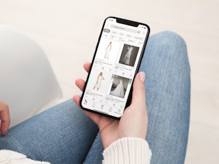 a person looking at poshmark on their iphone