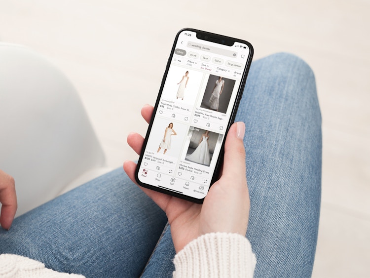a person looking at poshmark on their iphone