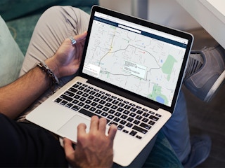 a person looking at the Area Median Income website on their macbook