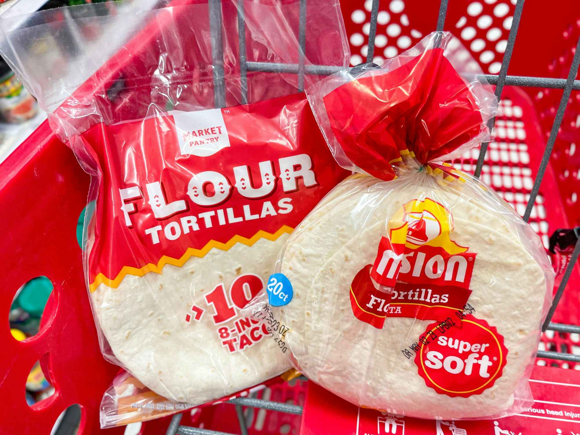 Some Market Pantry flour tortillas next to some Mission tortillas in a Target shopping cart