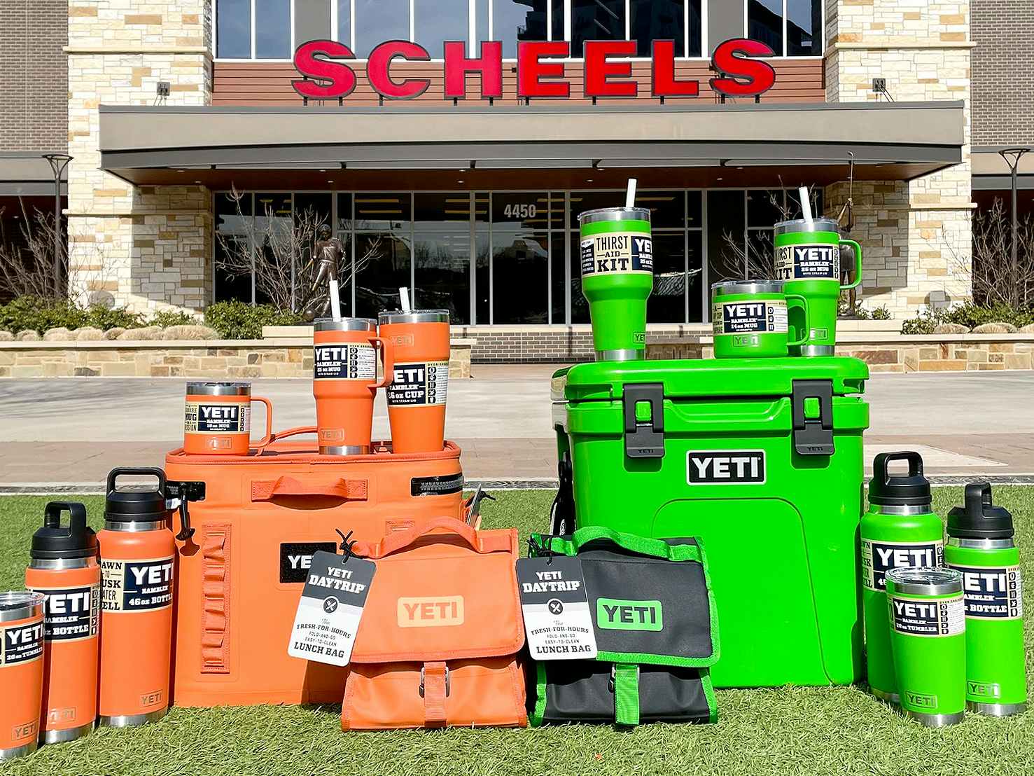 2023 orange and green yeti coolers and tumblers in front of scheels store exterior